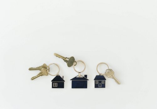 Housing Market concept - keys on house key rings, real estate, homes neighborhood equity buy sell